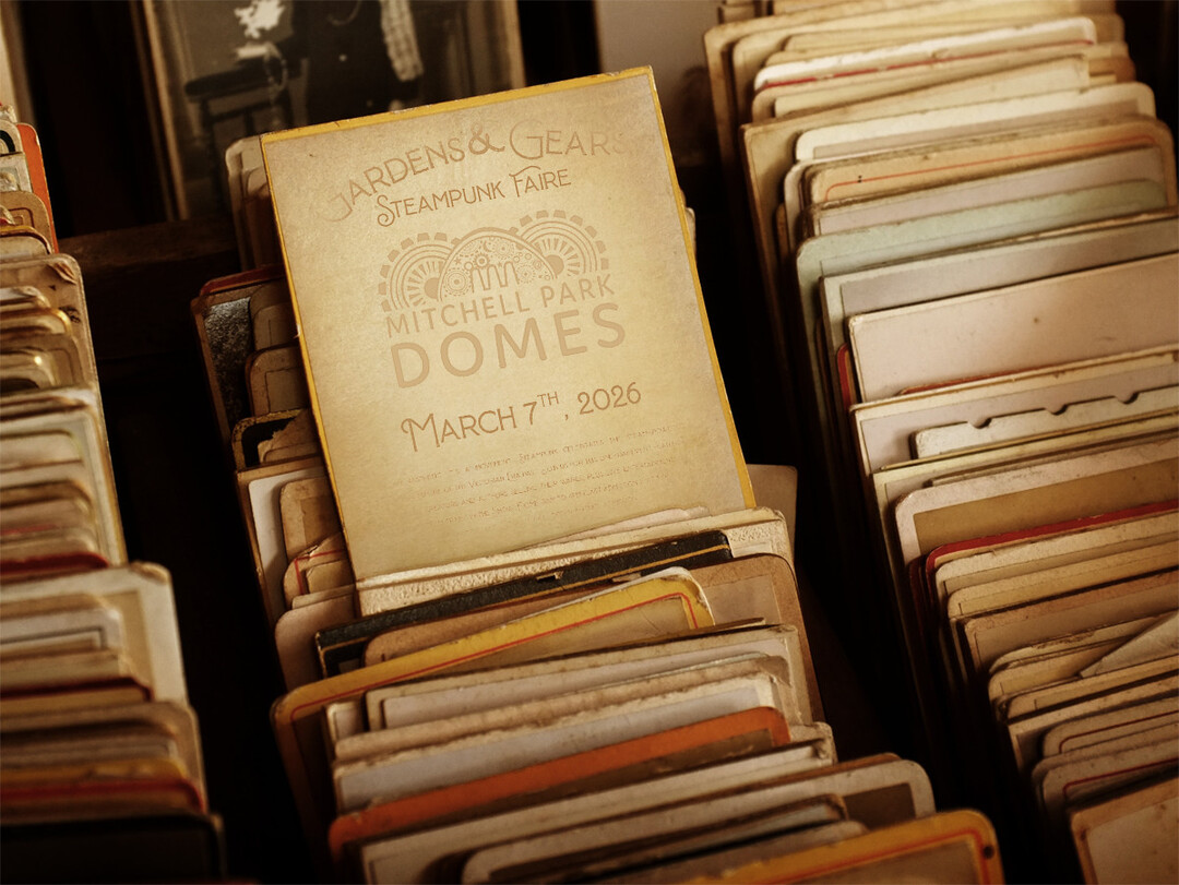 Amongst a large collection of vintage photographs, a weathered handbill from Gardens & Gears Steampunk Faire at the Mitchell Park Domes is pulled forth for you to examine.
